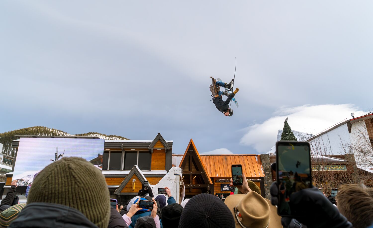 Skier flips in the air on Banff Avenue for Banff Skijoring at the SnowDays Festival
