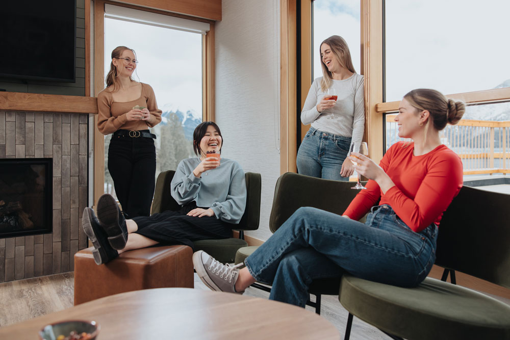 group of women sitting in a living area enjoying cocktails