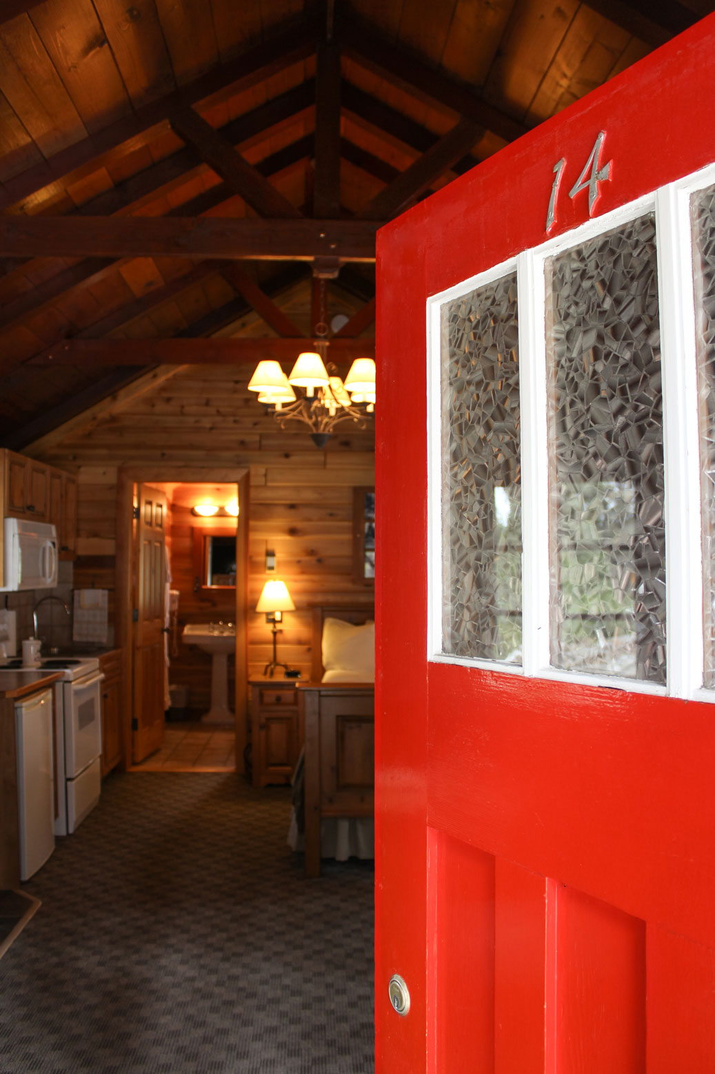 Red door opening up into a cabin at Paradise Lodge & Bungalows