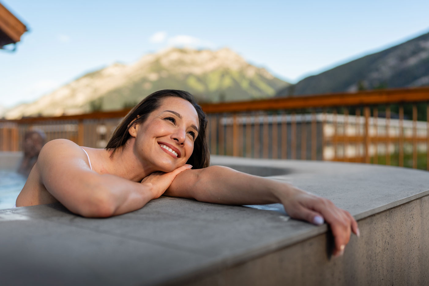 woman enjoying hot pools with mountain views in banff