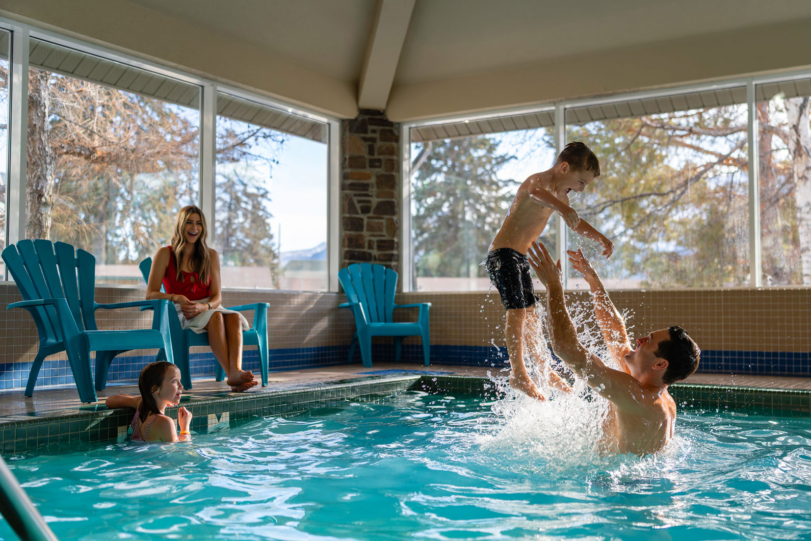 family playing in the pool at pocaterra inn