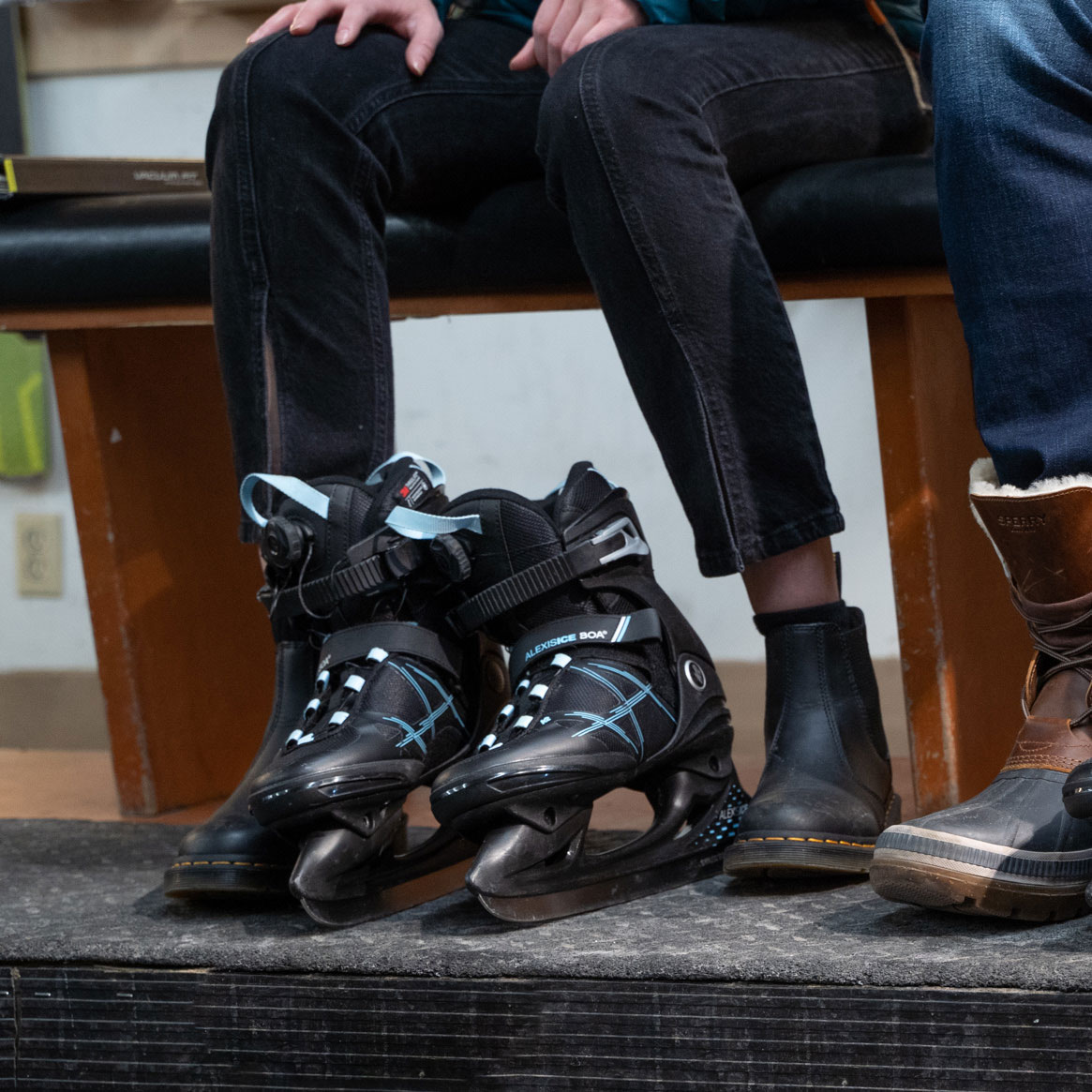 customer trying on winter skates rentals